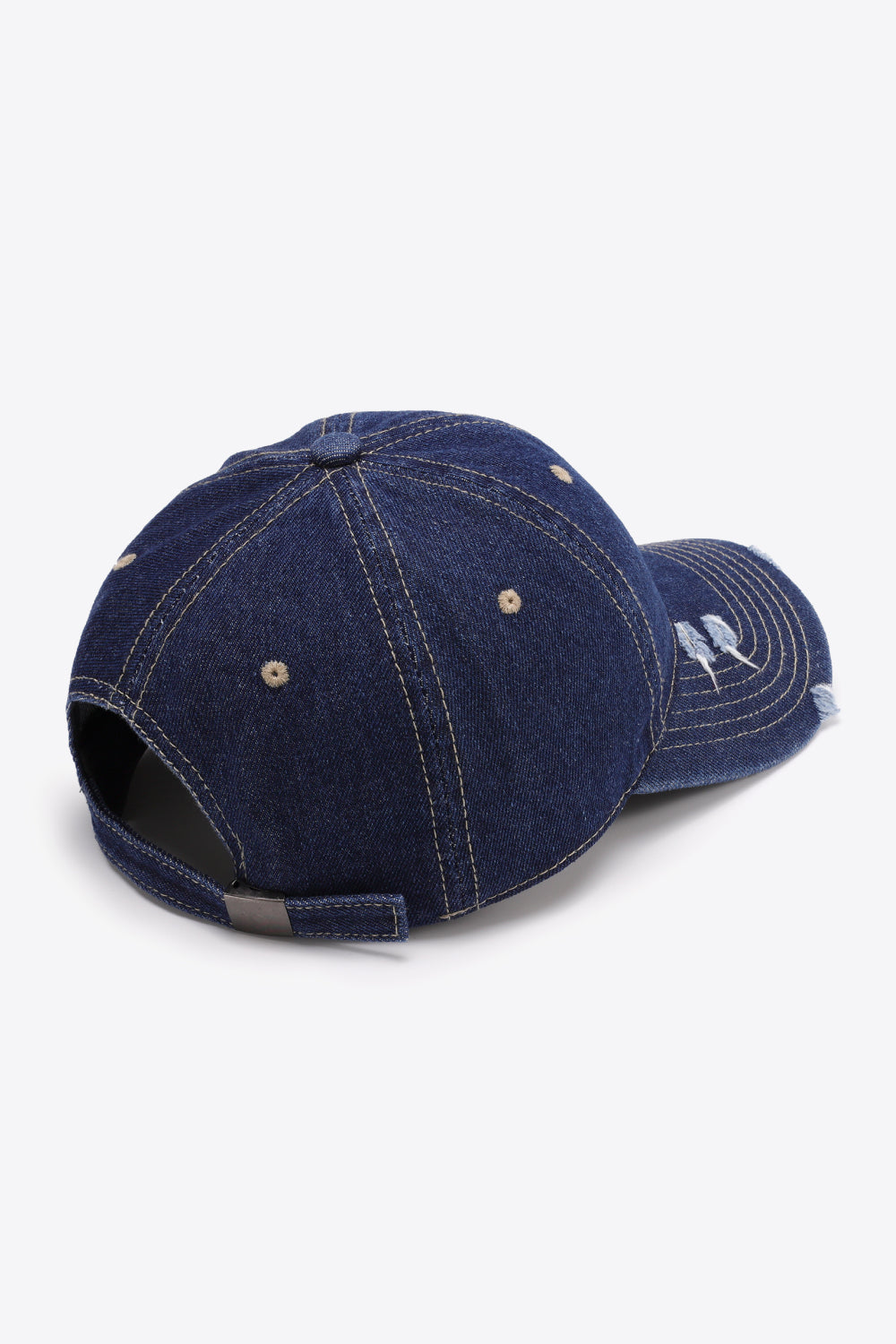 Denim baseball cap in dark navy with distressed brim and adjustable strap