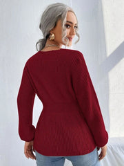 Wine peplum knit sweater with scallop neckline and long sleeves.