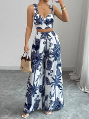Blue and white tropical print crop top and wide-leg pants set with sweetheart neckline and adjustable straps.