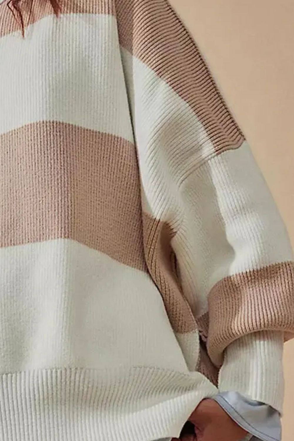 Checkerboard knit oversized sweater in dust storm with wide horizontal stripes and ribbed cuffs.