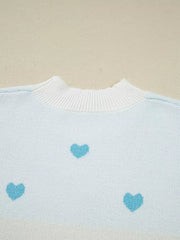 Light blue knit sweater with white crew neck and scattered blue hearts pattern.