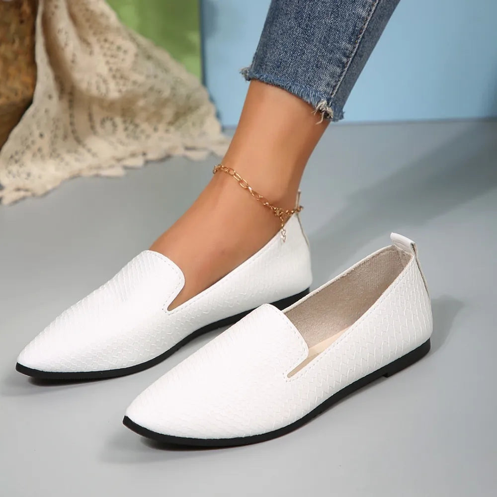 Textured white pointed-toe slip-on loafers with a subtle scale pattern.