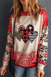 Heart graphic patchwork sweatshirt with buffalo plaid, leopard print, and stripes.