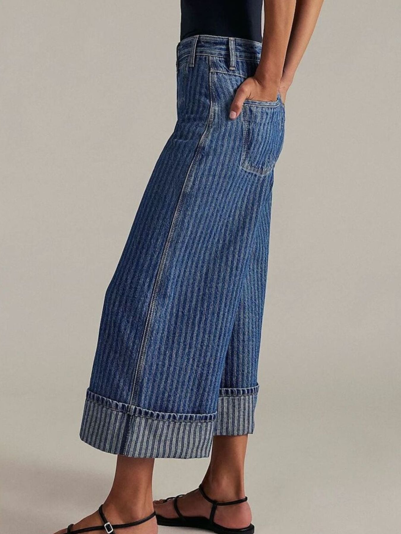 Dark blue striped high-waisted cropped jeans with cuffed hems.