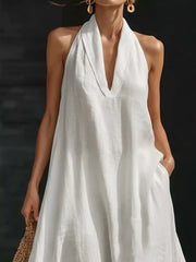 White halter neck maxi dress with pockets, deep V-neck, 100% polyester.