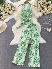 Green tropical print halter top and wide-leg pants set with belted detail
