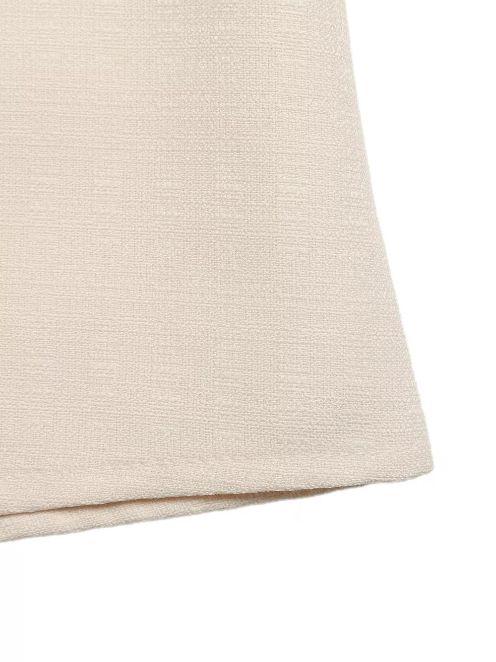 Embellished linen two-piece set in cream, showing textured fabric detail.