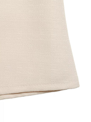 Embellished linen two-piece set in cream, showing textured fabric detail.