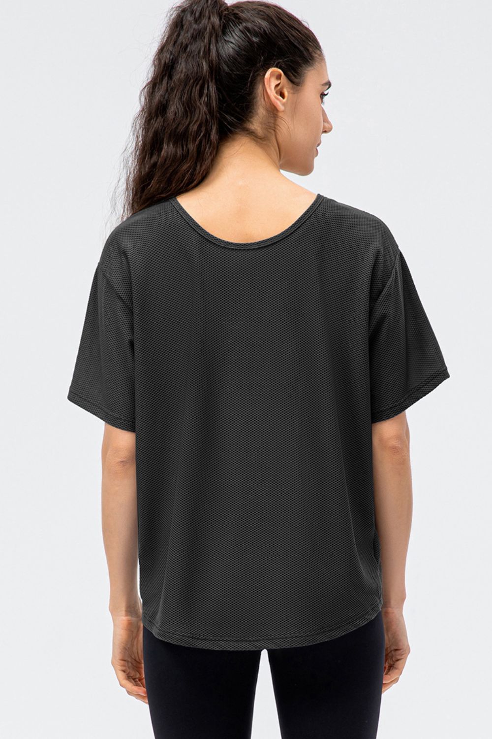 Black honeycomb mesh performance t-shirt with a scoop neck and short sleeves.