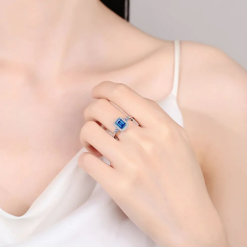 Emerald cut royal blue moissanite halo ring in sterling silver