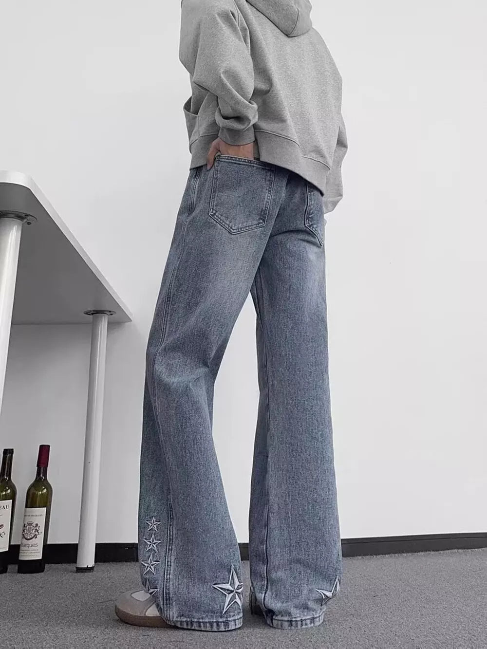 Blue 100% cotton wide-leg jeans with embroidered star details on the hem.