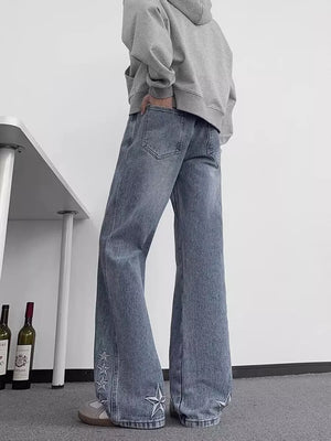 Blue 100% cotton wide-leg jeans with embroidered star details on the hem.
