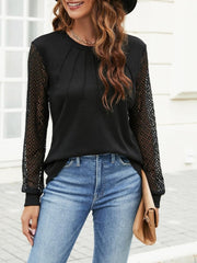 Black waffle knit top with lattice sleeves and pleated neckline detail.