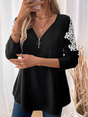 Black ribbed knit zip-front top with white lace trim on the sleeves.
