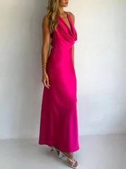 Rose red satin halter maxi dress with asymmetric neckline and body skimming fit.