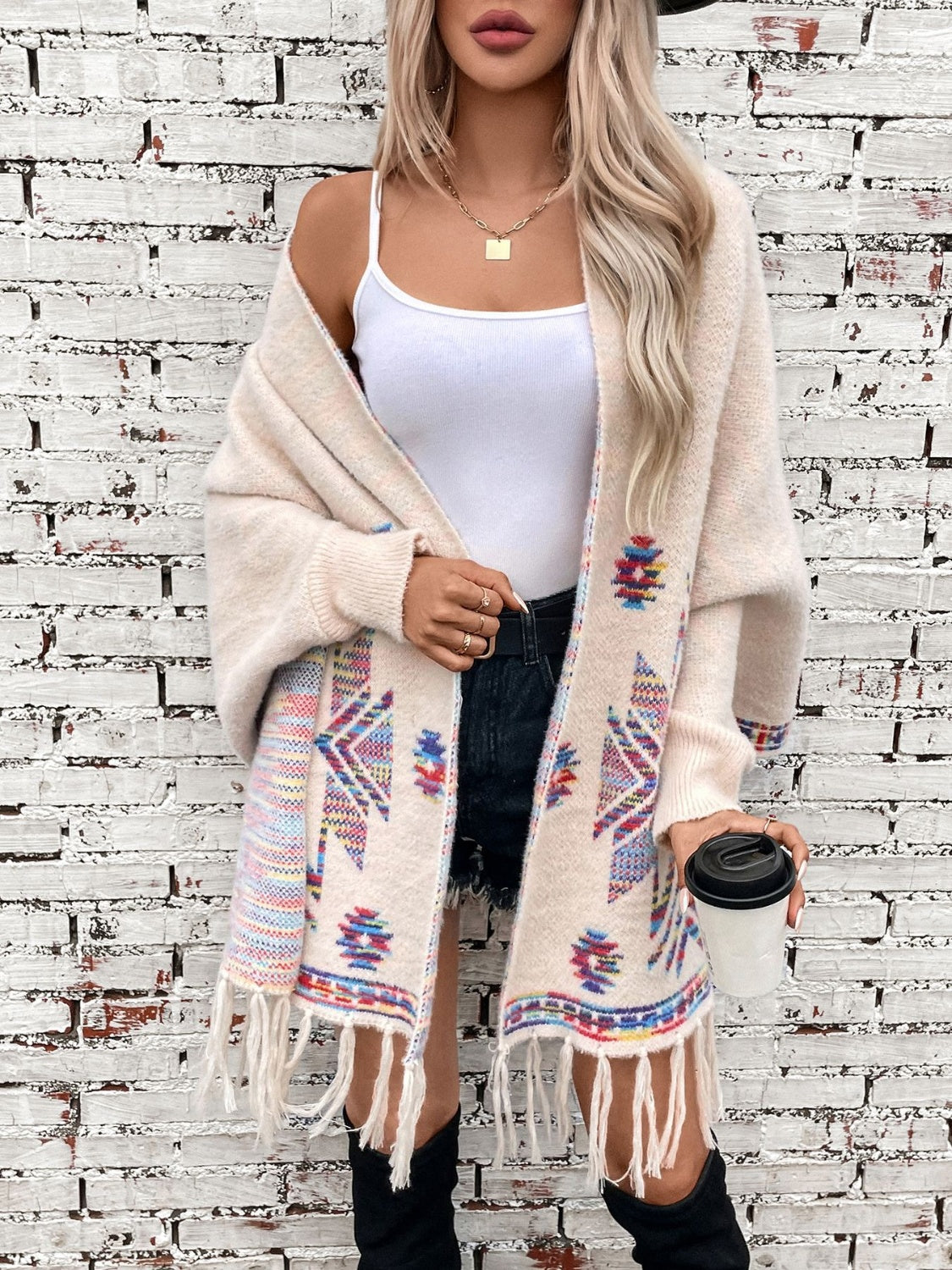 Cream Aztec fringe knit cardigan with colorful geometric pattern and open front.