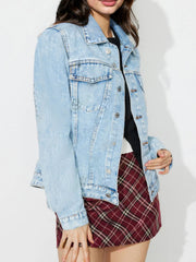 Light wash denim jacket with classic buttoned front and chest pockets.