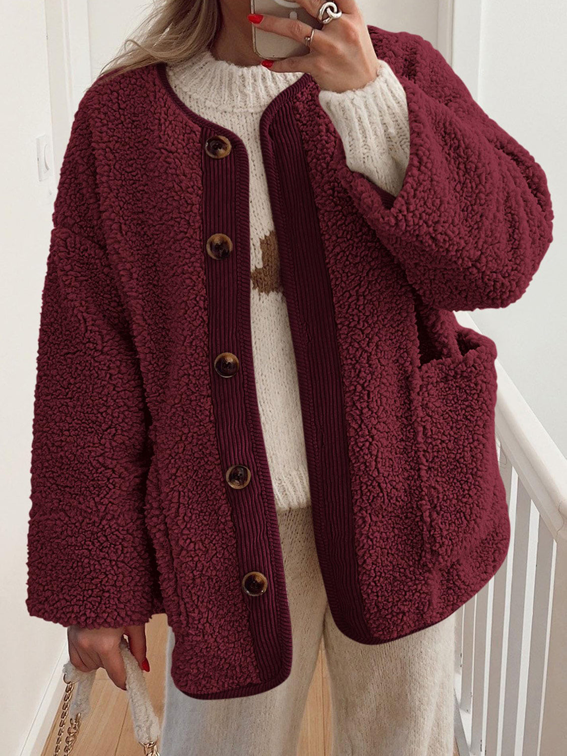 Burgundy teddy-texture button-up jacket with corduroy trim and pockets.