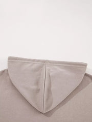Relaxed fit cotton hoodie in a light taupe multi-tonal shade, showing the hood seam detail.