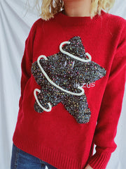 Scarlet knit jumper with a textured starburst applique and white piping detail.