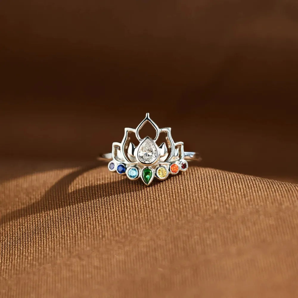 Sterling silver ring with lotus design and colorful chakra gemstones.