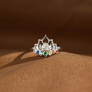 Sterling silver ring with lotus design and colorful chakra gemstones.