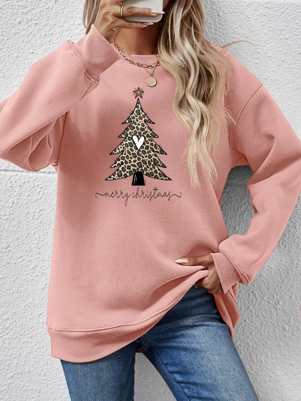 Blush pink sweatshirt with leopard print Christmas tree graphic and "merry christmas" text.