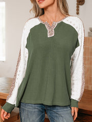 Dark green waffle knit henley top with lace sleeves and leopard print trim.