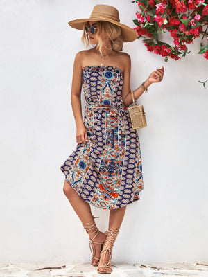 Printed bandeau midi dress with asymmetric hem and belt in dark blue.