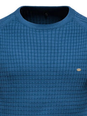 Peacock blue crewneck sweater with textured grid pattern and small oval logo detail.