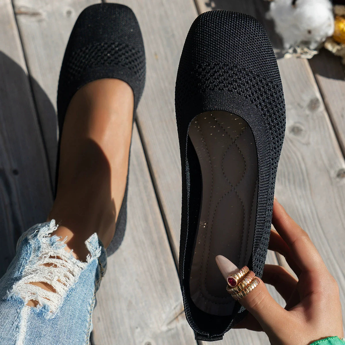 Black breathable knit square-toe flats with a textured pattern.