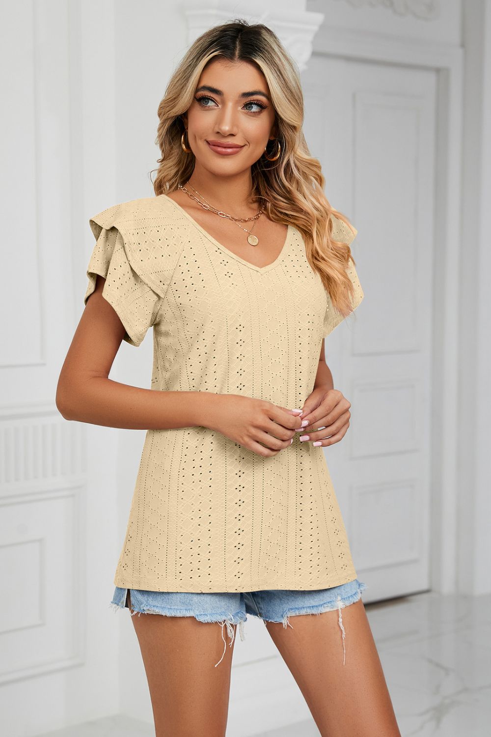 Light Yellow eyelet knit blouse with V-neck and flutter sleeves.
