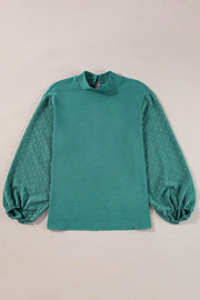 Teal textured blouson top with Swiss dot balloon sleeves and mock neck