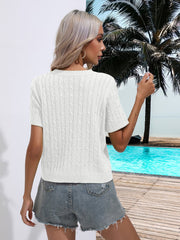 White cable knit crew neck sweater with short sleeves.