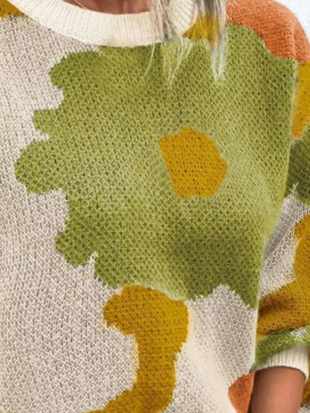 Abstract floral knit sweater with round neck in green, yellow, and cream.