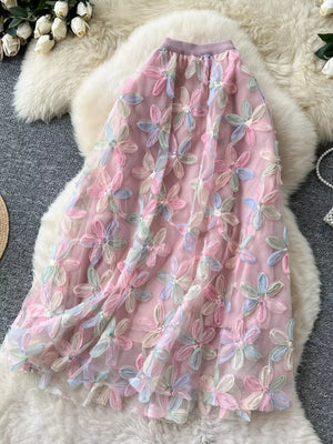 Embroidered floral layered skirt in pink with pastel flowers and sequin details.