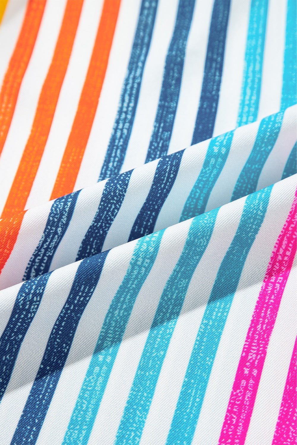 Relaxed fit button-down shirt with vibrant rainbow stripes in orange, blue, and pink.