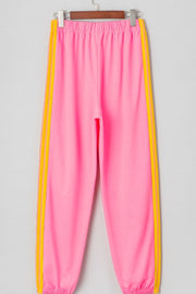 Pink track pants with yellow double stripes down the sides.