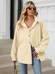 Oversized cream corduroy shirt jacket with button front and collar.