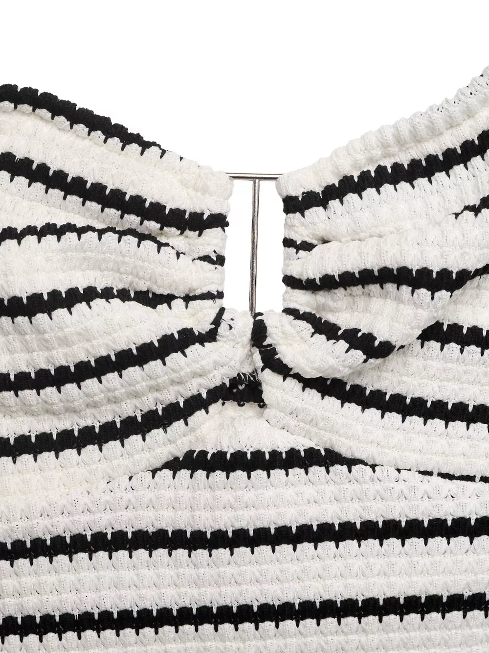 Chic cutout knit mini dress with black and white stripes and a metal detail.