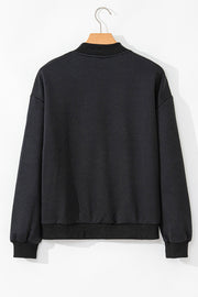 Black bomber jacket with textured diamond quilting and ribbed collar, cuffs, and hem.