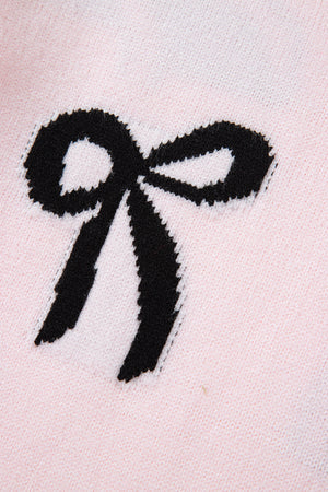 Blush pink knit sweater with a black bow motif detail.