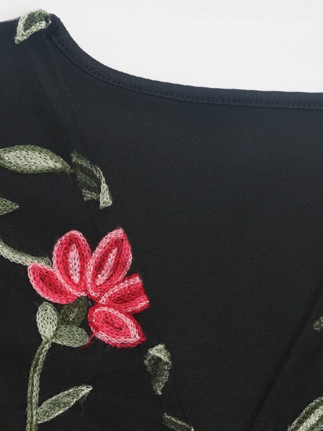 Black bodysuit with embroidered red floral and green leaf details
