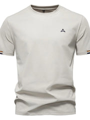 Beige t-shirt with embroidered crest detail and striped sleeve cuffs