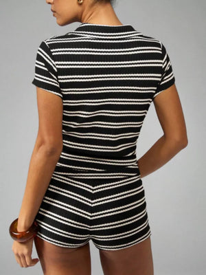 Chic striped knit two-piece set in black stripes, featuring a short sleeve top and high-waisted shorts.