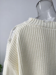 Off white distressed cotton sweater with deconstructed shoulder details and ribbed texture.