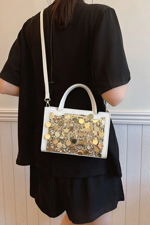 White structured mini bag with gold sequin embellishments and top handles.