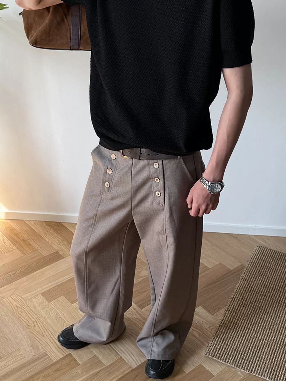 Mocha high-waisted wide leg pants with button detail and a belt.