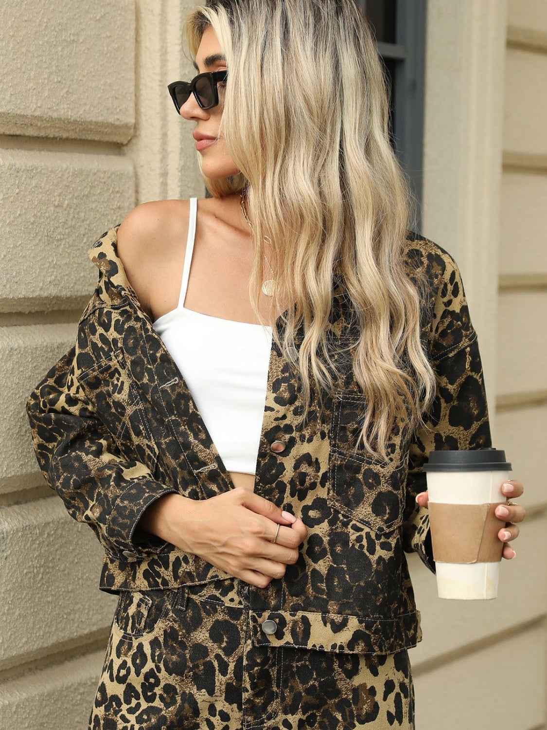 Leopard print denim jacket with button front and chest pockets.