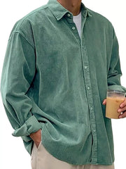 Men's green corduroy button-up shirt with classic collar and long sleeves.